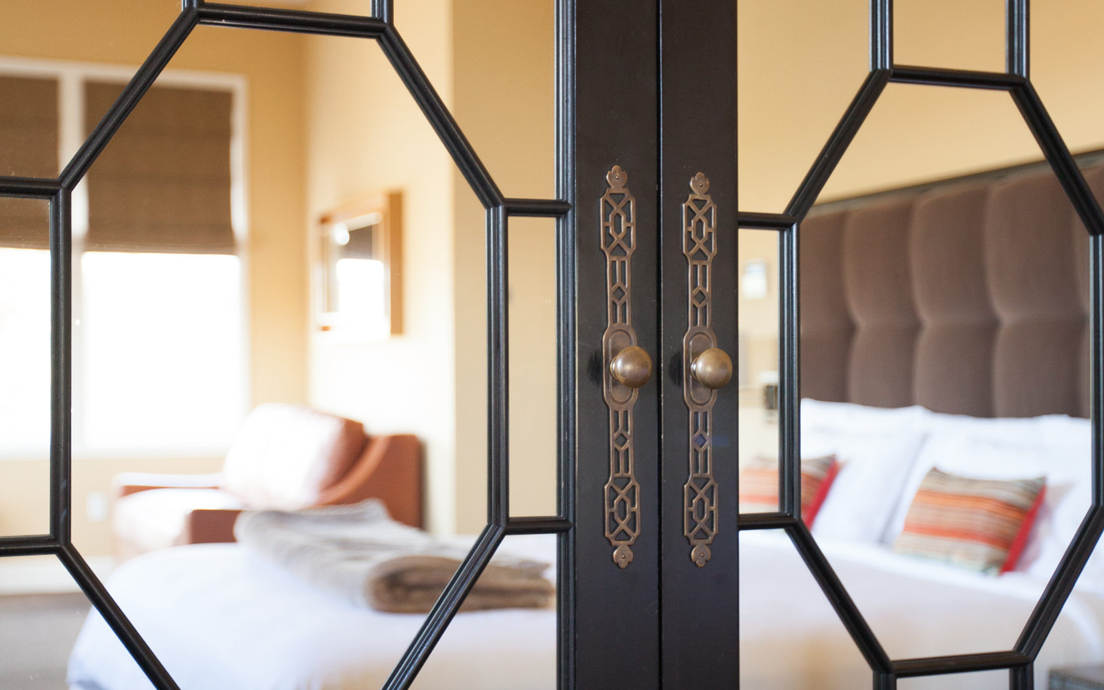 detail of cabinet hardware and bedroom reflection